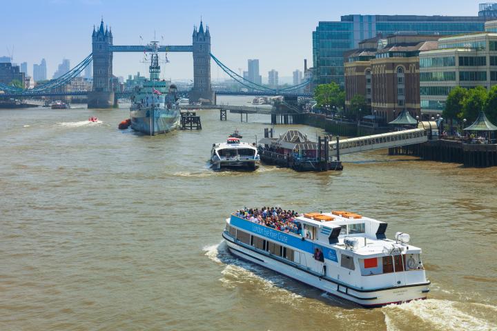Boats on the River Thames near Tower Bridge on a sunny day.
